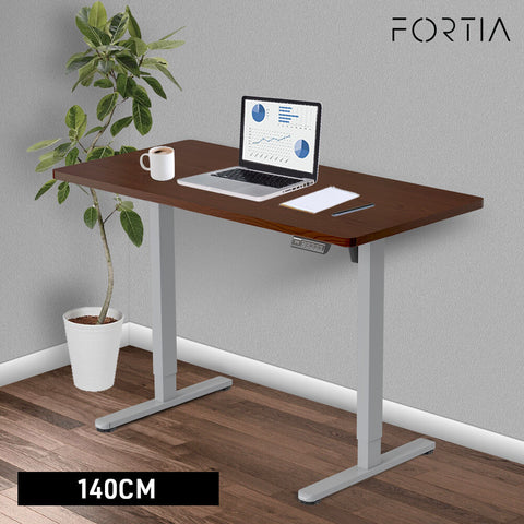 FORTIA Sit To Stand Up Standing Desk, 140x60cm, 72-118cm Electric Height Adjustable, 40kg Rated, Walnut Style/Silver Frame